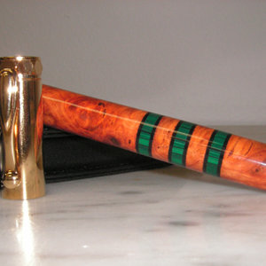 Amboyna and Malachite with black pick guard segments on a Zen rollerball