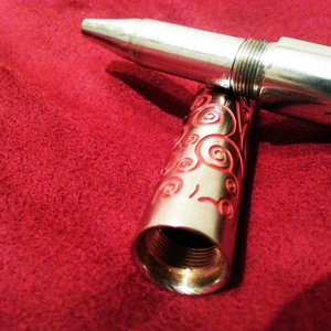 Chrome plated from head to toe, luxurious deep red swirls etched throughout.