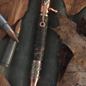 Bolt action Deer Hunter in stabilized buckeye burl with copper hardware.