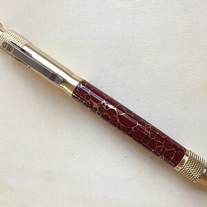 bolt action in red trustone with gold web