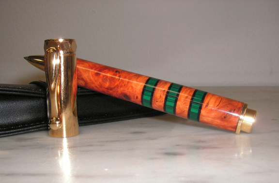 Amboyna and Malachite with black pick guard segments on a Zen rollerball