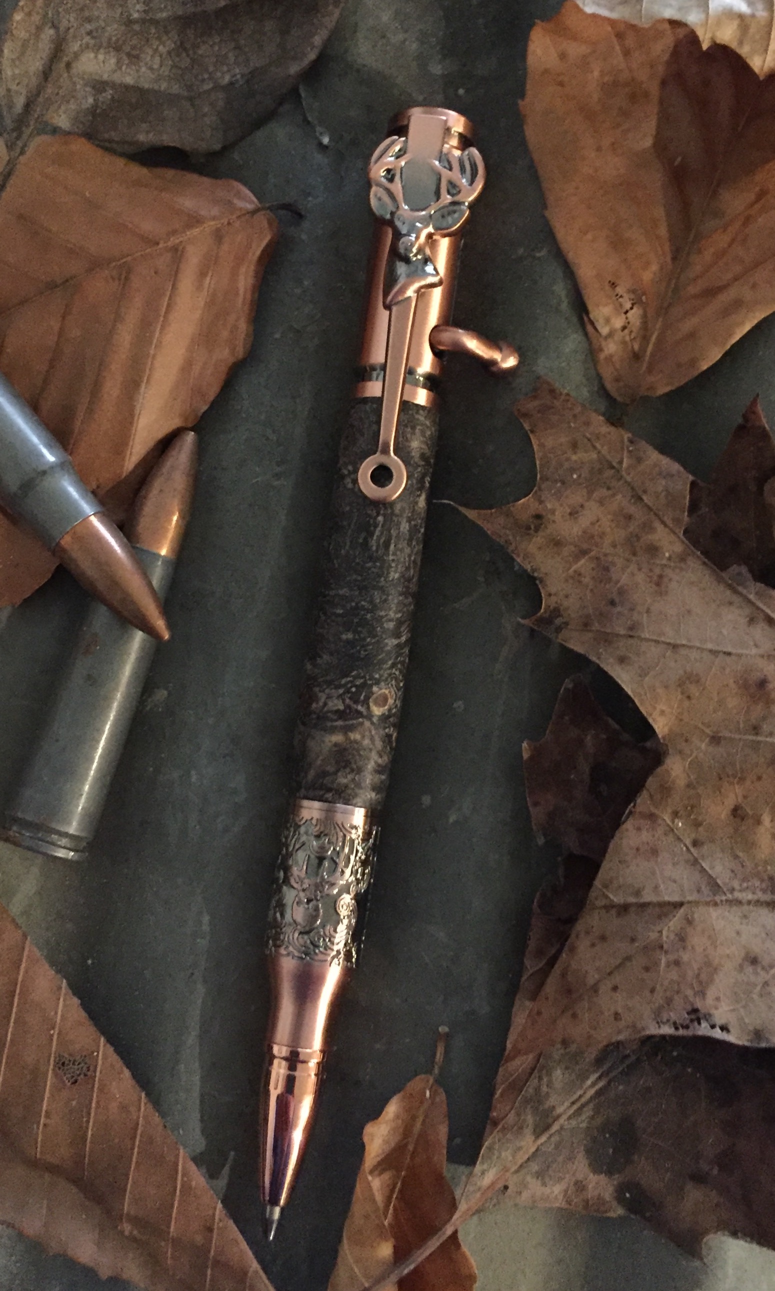 Bolt action Deer Hunter in stabilized buckeye burl with copper hardware.