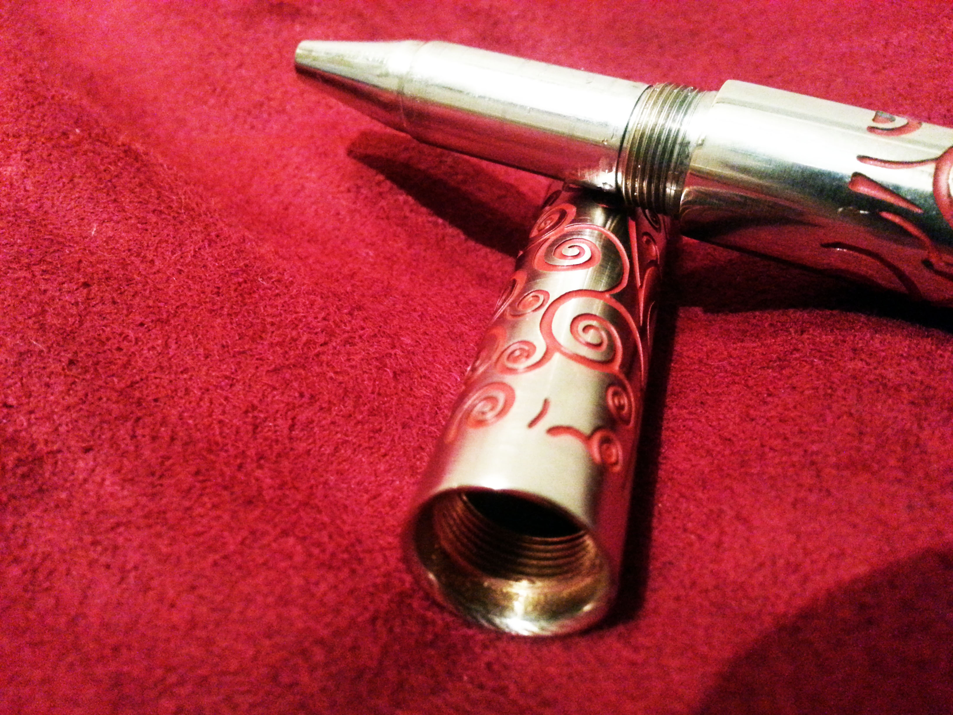 Chrome plated from head to toe, luxurious deep red swirls etched throughout.