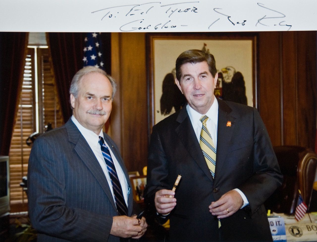 Gov Bob Riley with "The Pen" made from Avondale Mill maple flooring