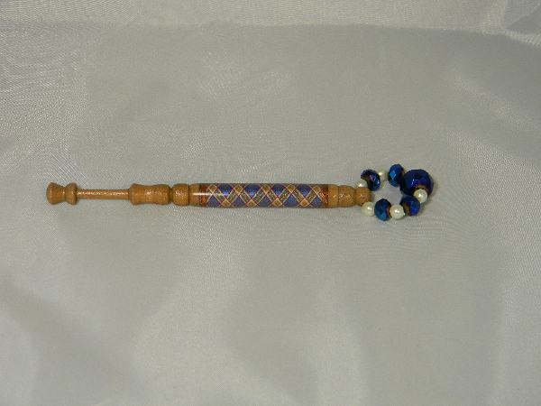 Lace bobbin with thread decorations
