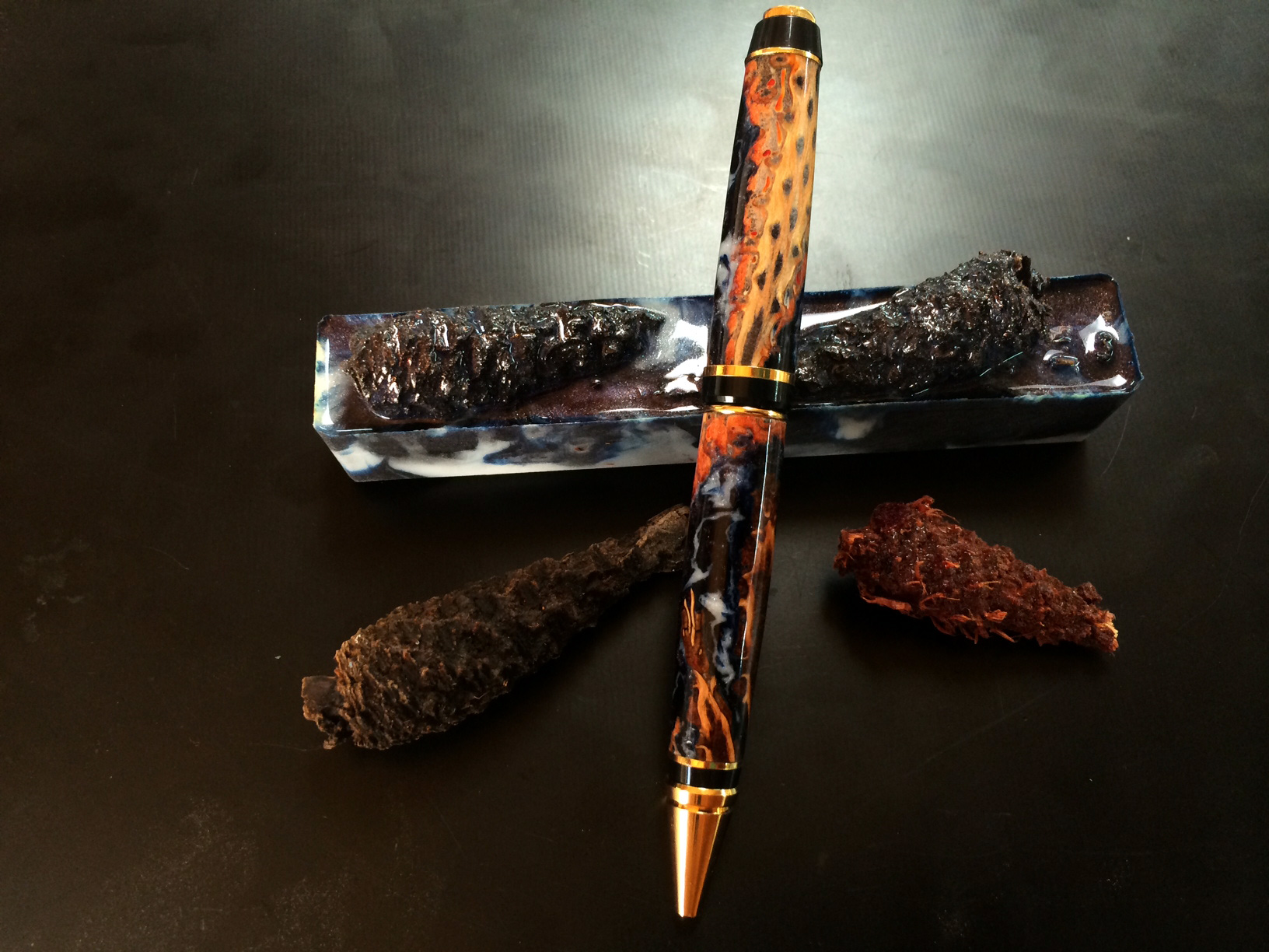 small pine cones in blue galaxy alumilite resin